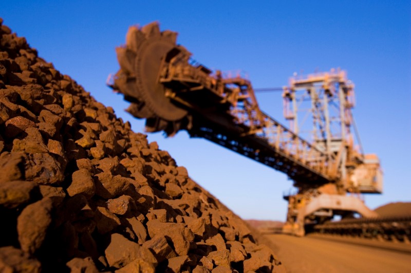A stack reclaimer with a pile of iron ore at the Rio Tinto Parker Point ship loading terminal in Western Australia
