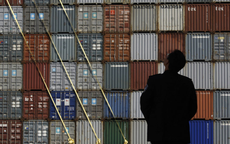 Security guard stands in front of the Yantian International Container Terminal in the southern Chinese city of Shenzhen